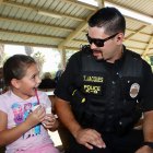 Lemoore officer Tanner Jacques spends a moment with Sophia Henderson.